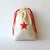 8 muslin bags with embroidered red star
